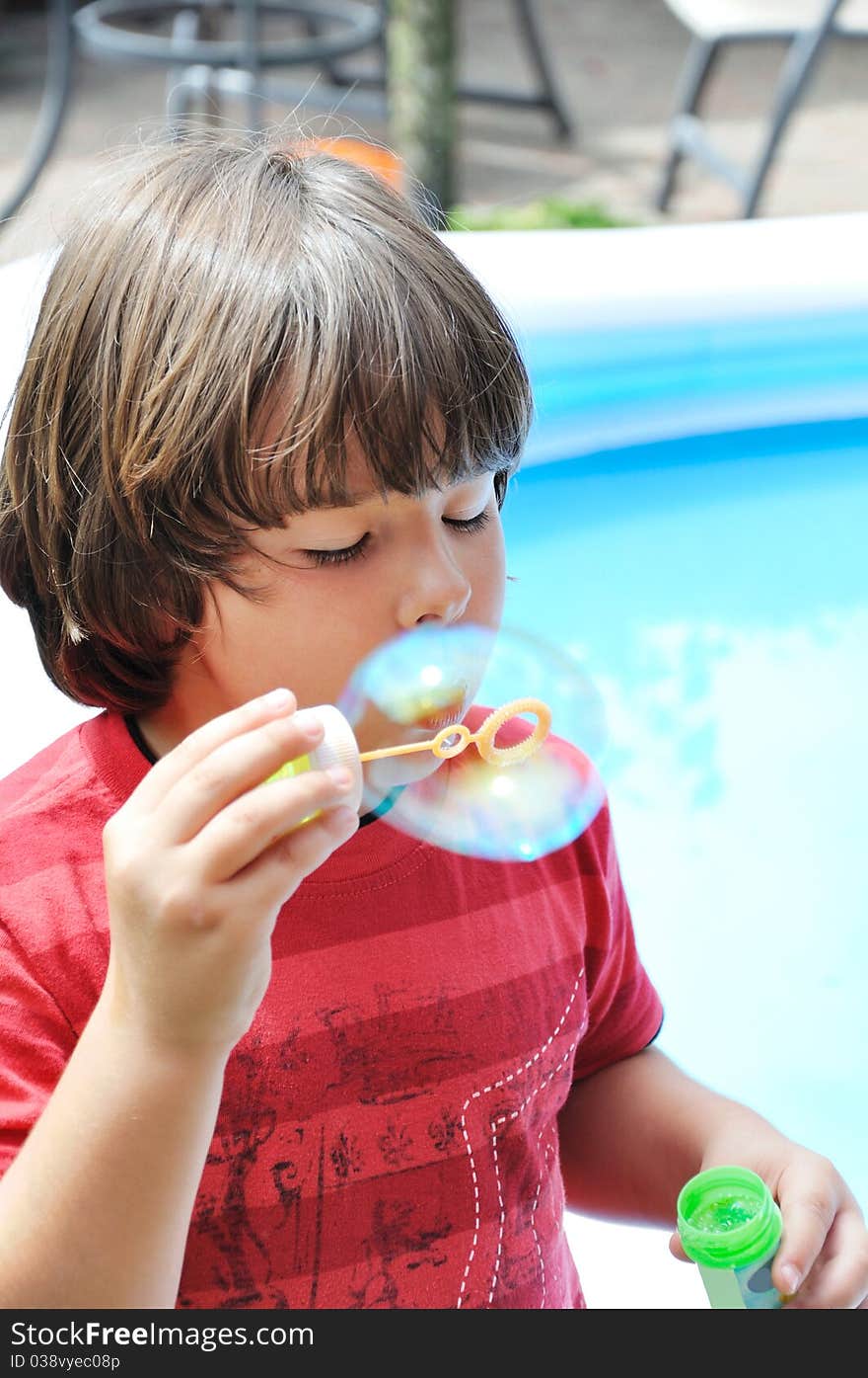 Little boy blowing bubbles