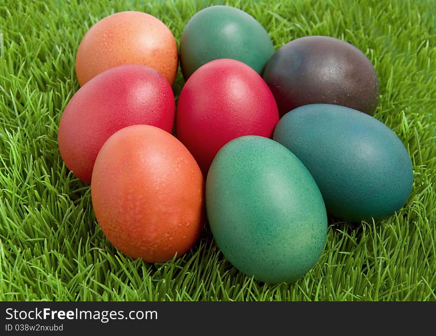 Colorful easter eggs on green grass