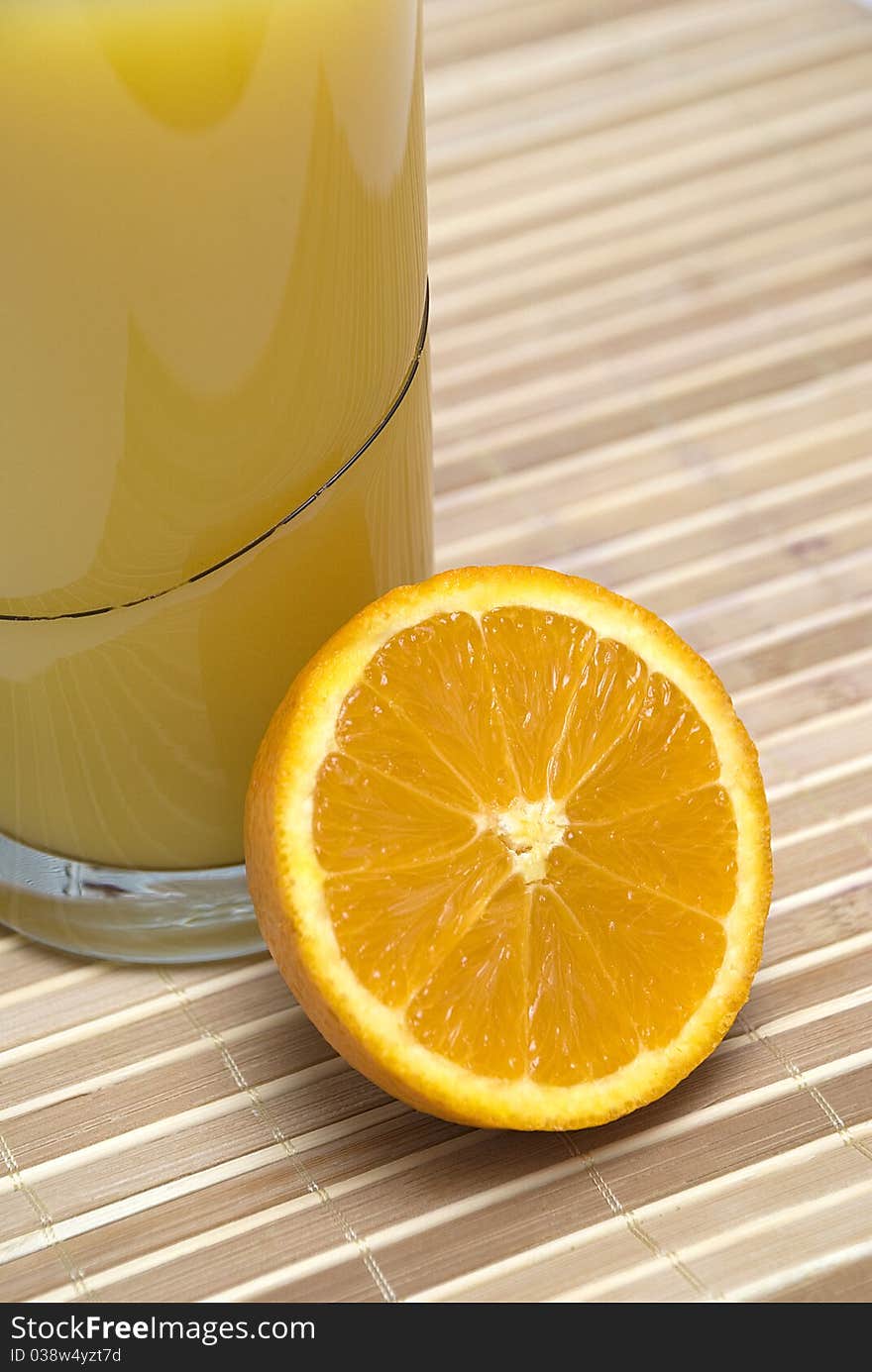 Glass with orange juice and a sliced orange