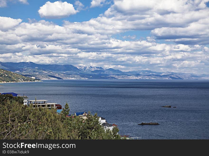 Mountains andcloudy blue heaven and sea