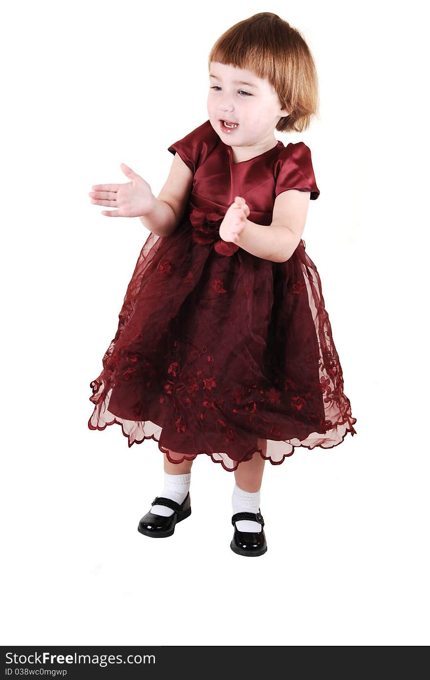 A sweet little girl, three years old, in a nice burgundy dress having fun, for white background. A sweet little girl, three years old, in a nice burgundy dress having fun, for white background.