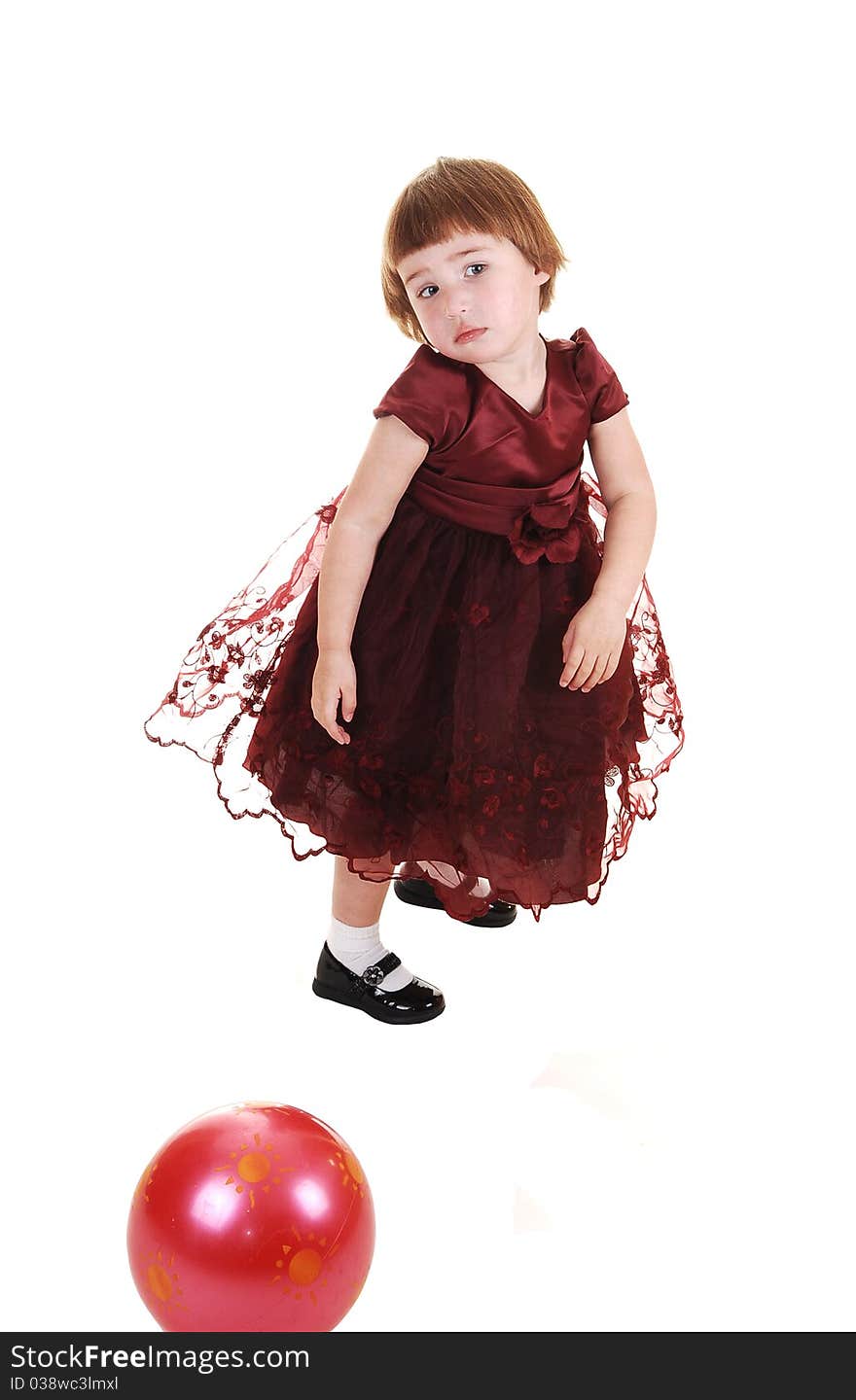 A sweet little girl, three years old, in a nice burgundy dress having fun, for white background. A sweet little girl, three years old, in a nice burgundy dress having fun, for white background.