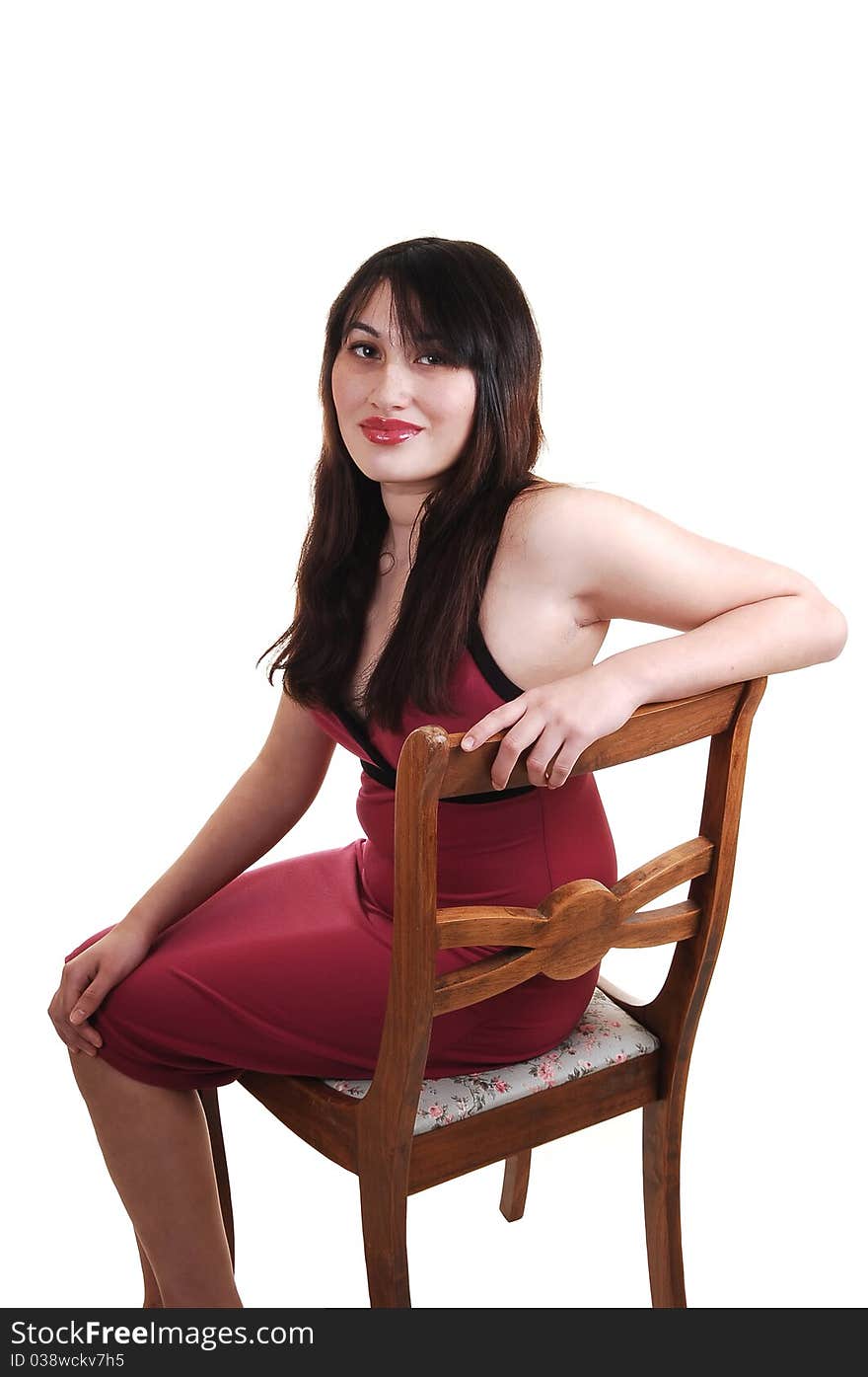 A young girl sitting on an old chair, for white background.