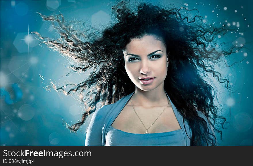 Woman with a long beautiful hair on blue background