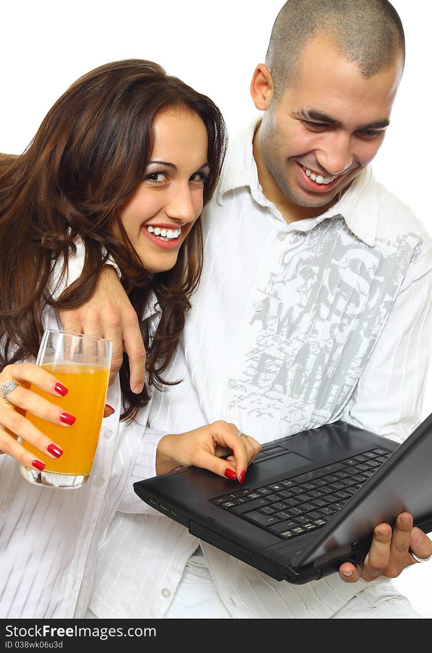 Smiling young couple with laptop isolated on white