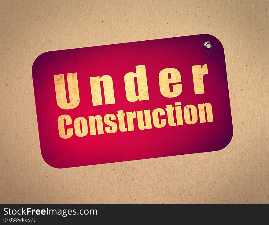 Red billboard with under construction text over wooden background