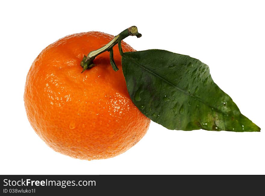 Ripe tangerine with green leaf.