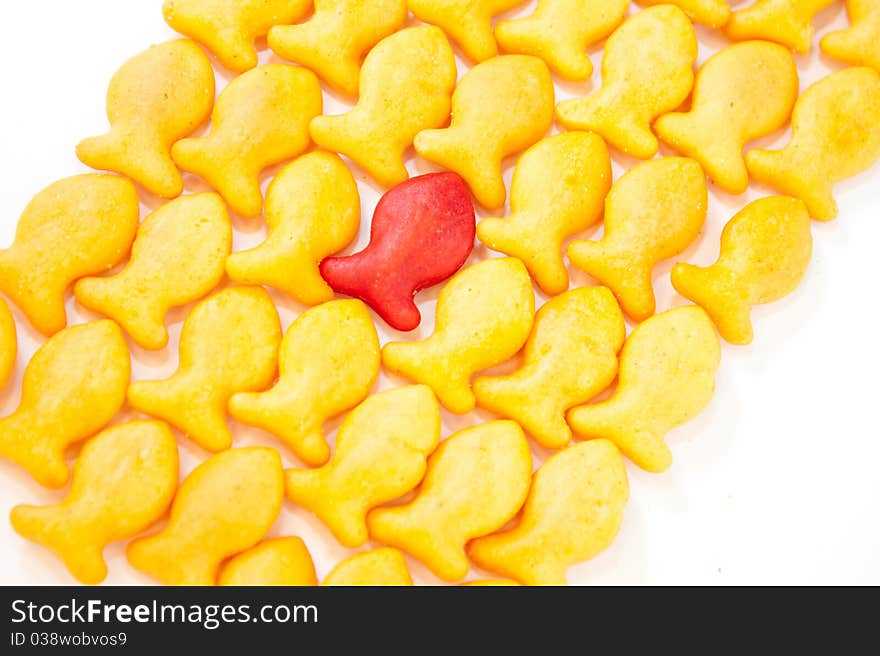 Gold Fish Crackers. One red. Background.