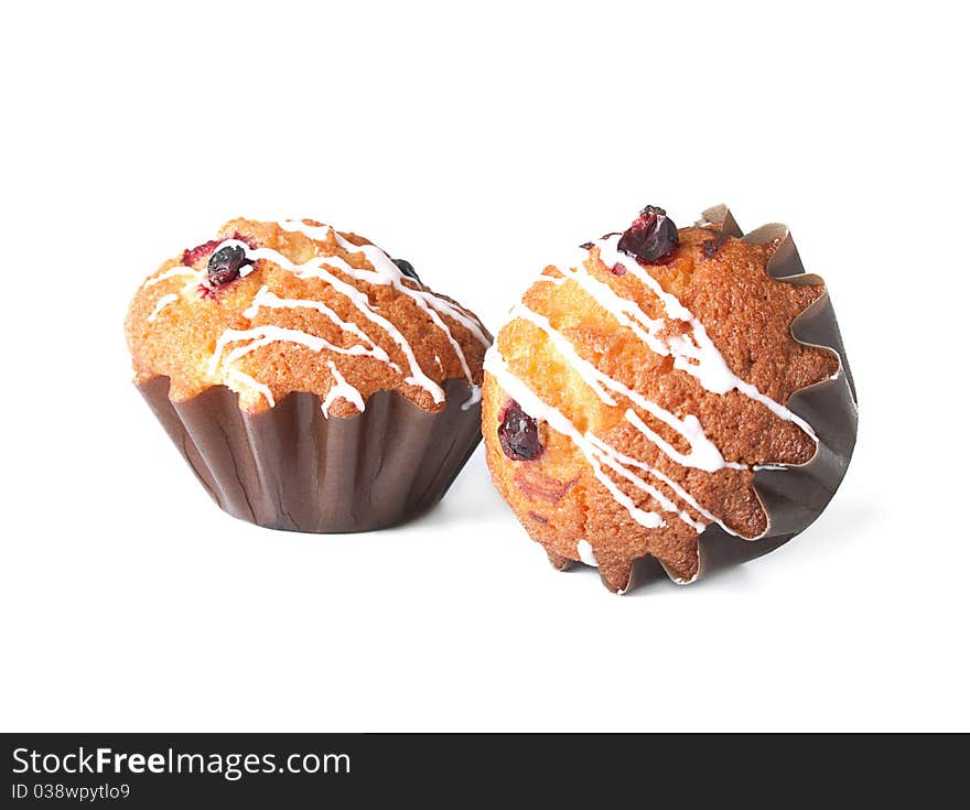 Muffins with red bilberry on a white background