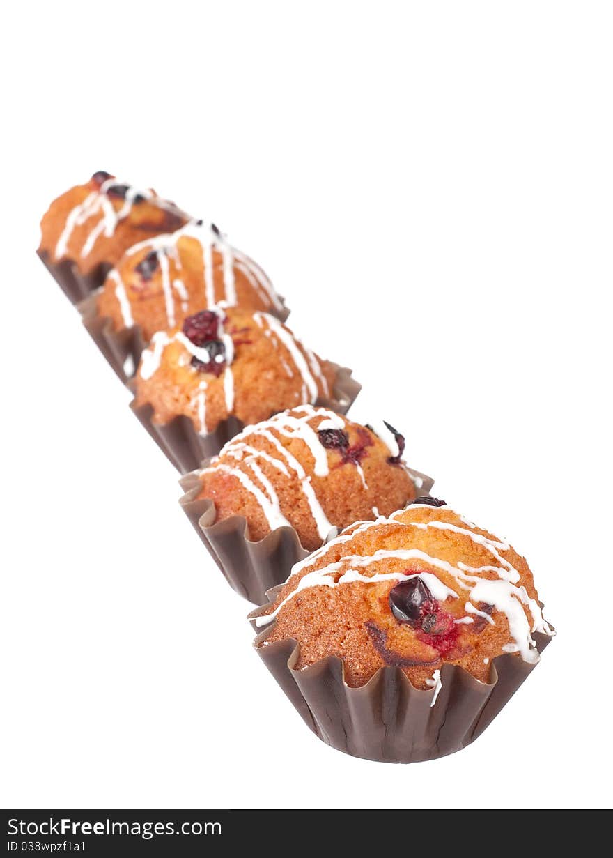 Muffins with red bilberry on a white background