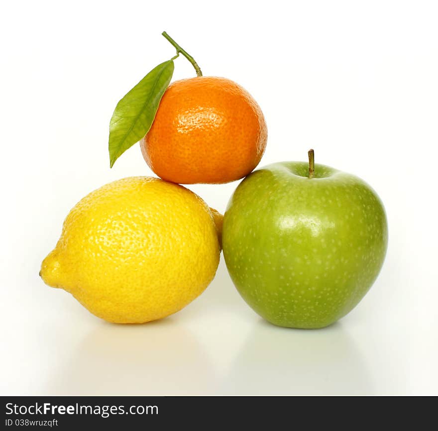 Fresh ripe fruits tangerine, lemon, apple on white background. Fresh ripe fruits tangerine, lemon, apple on white background