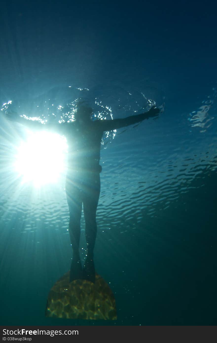 Man freediving in a monofin