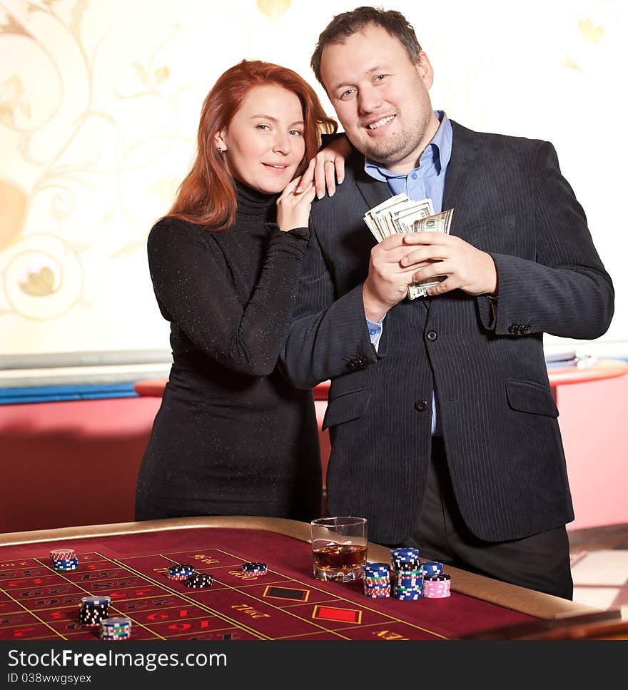 Happy Pair With Money Near Roulette Table