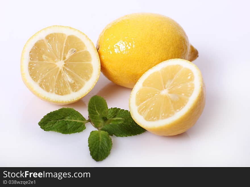 Two lemon with fresh green mint isolated. Two lemon with fresh green mint isolated