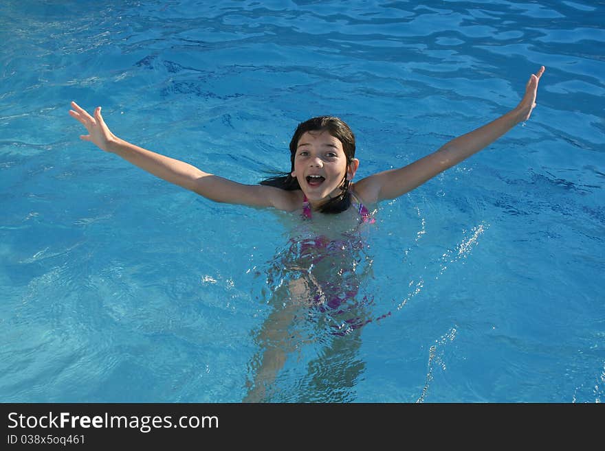 Girl making a splash in the water. Girl making a splash in the water.