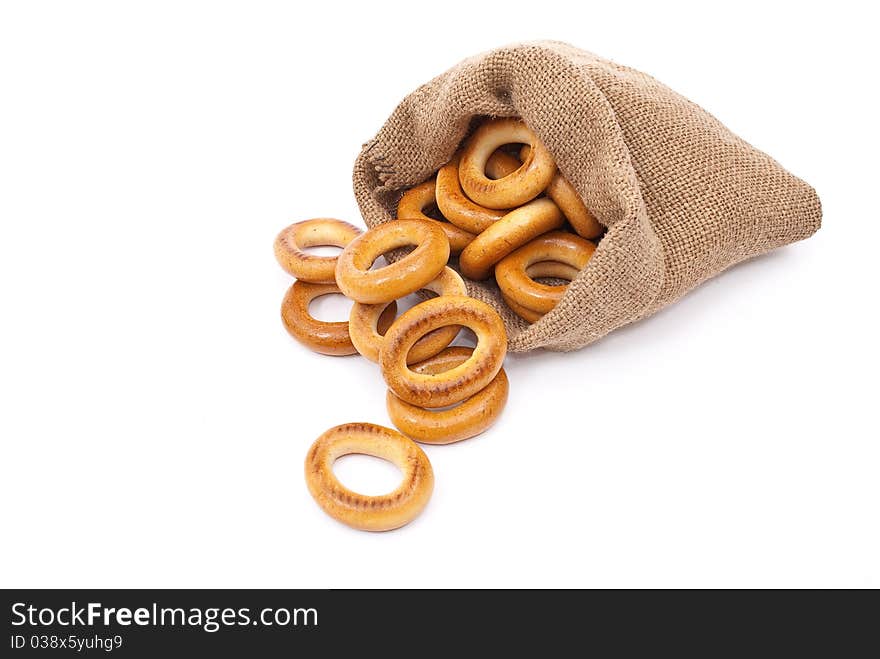 Burlap sack with bagels on white