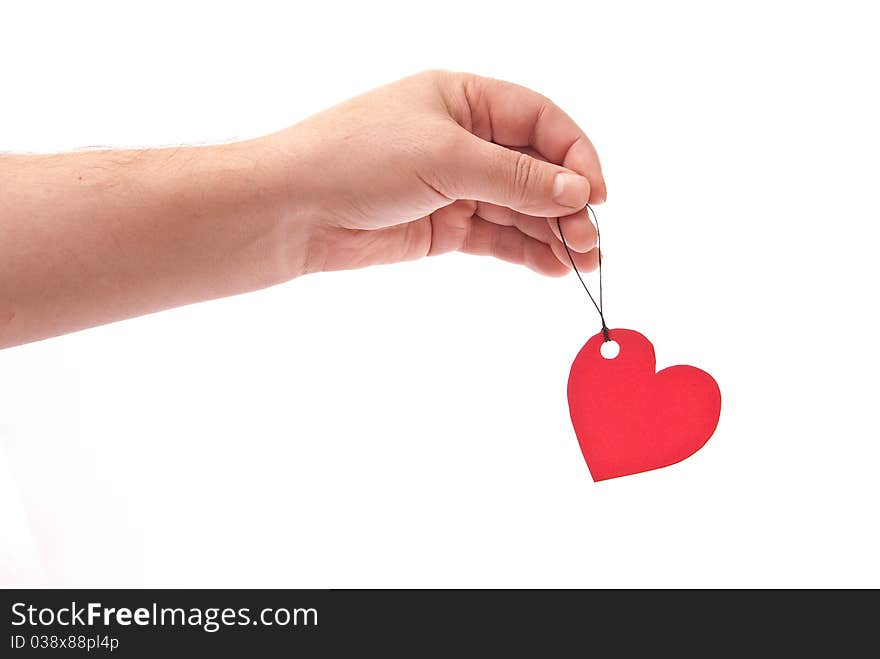 Hand with red heart tag on white