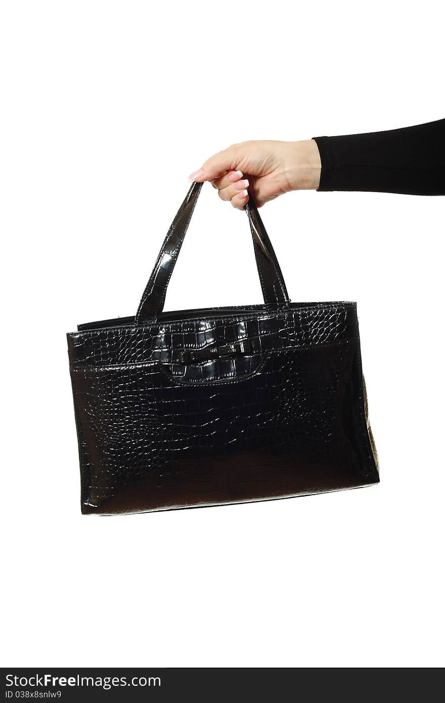 Woman hand with black leather bag isolated over white