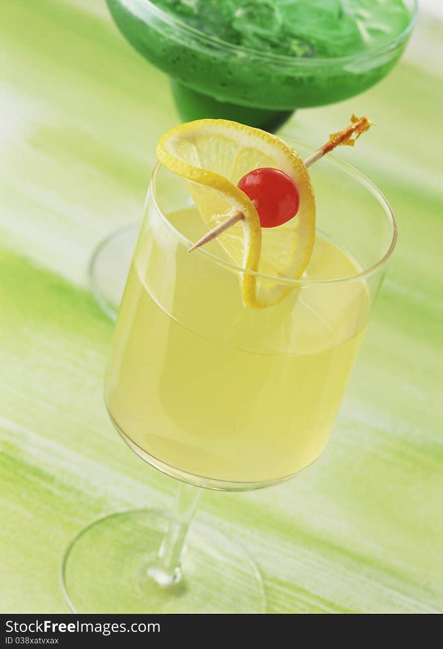 Rum punch, drink glass isolated on green background. Rum punch, drink glass isolated on green background