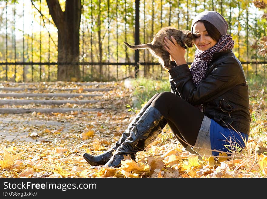 Young girl with a kitten outdoors