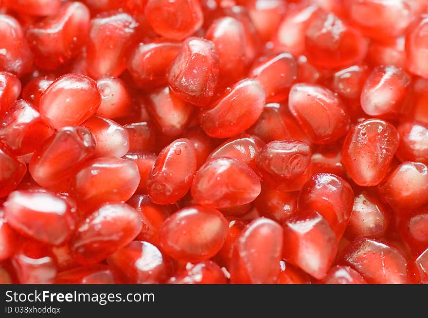 Macro of peeled ripe seeds pomegranate background