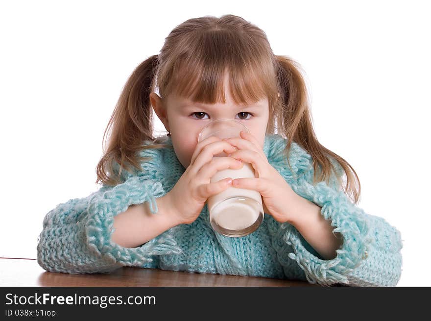 The little girl with a milk glass on white