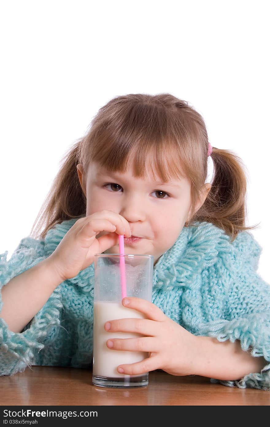 The little girl with a milk glass on white