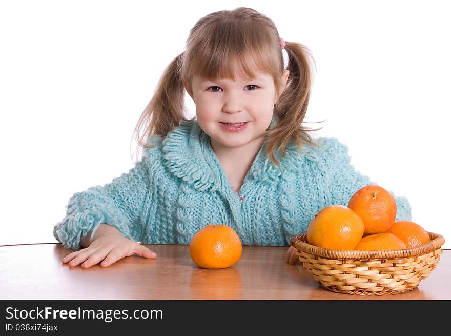 The little girl with tangerines on white