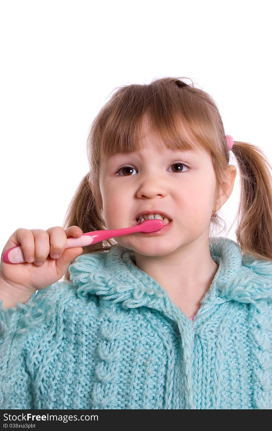 The little girl cleans a teeth on white