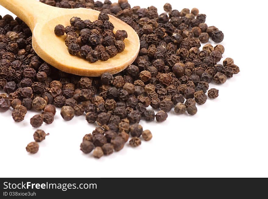 Black Peppercorns On A Wooden Spoon