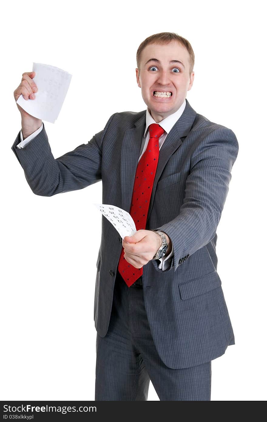 Young businessman in a rage tearing paper