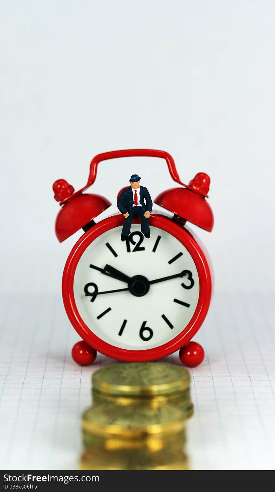 A red alarm clock with the bank manager sat on it with a stairway of gold coins in front it, signifying the longevity of the loan. A red alarm clock with the bank manager sat on it with a stairway of gold coins in front it, signifying the longevity of the loan.