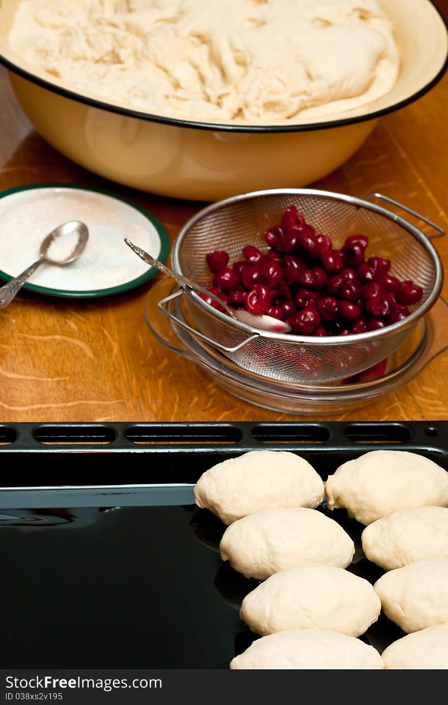 Small pies with cherry on a table. Small pies with cherry on a table