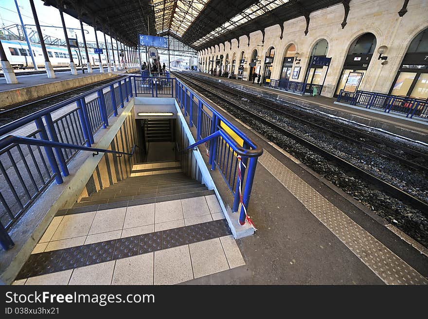 Stairs to cross the tracks of a train station. Stairs to cross the tracks of a train station