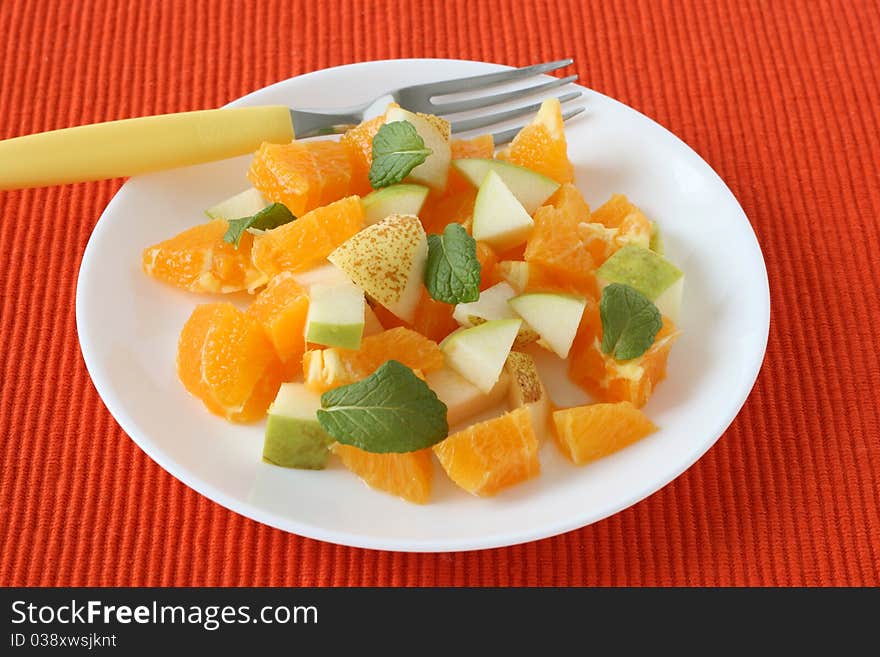 Fruit salad with mint on a plate