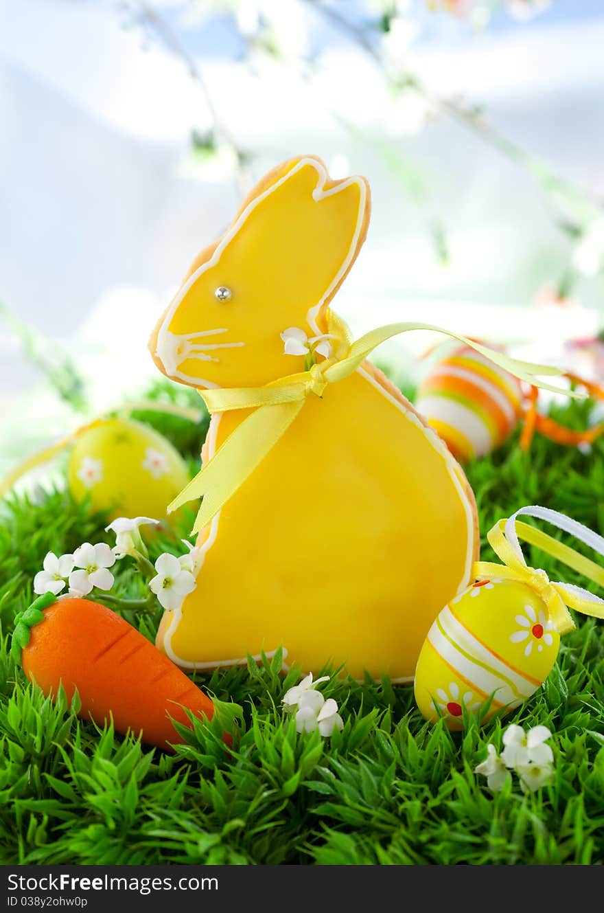 Homemade Easter bunny cookies and easter eggs on the grass