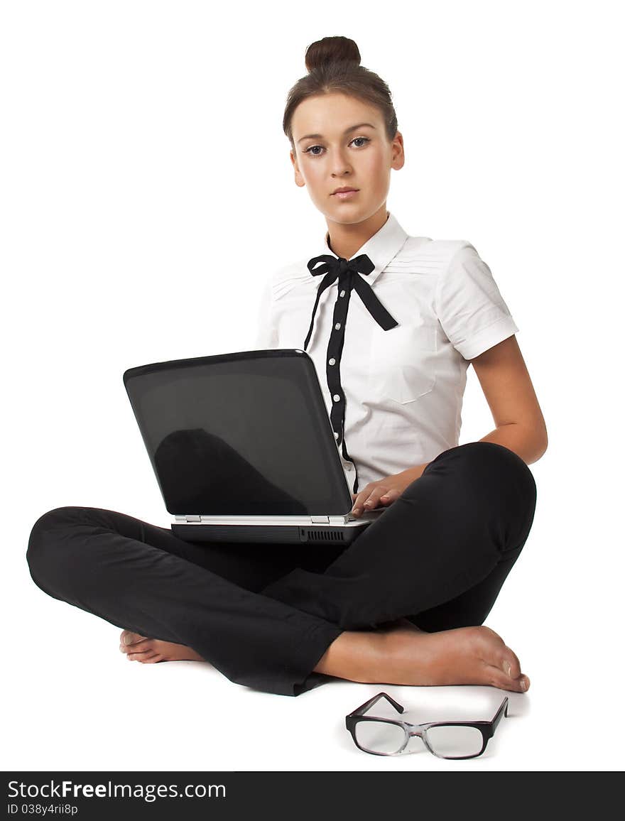 Beautiful girl sitting on the floor and works on a laptop keep the glasses in her hand isolated on white background Student Series