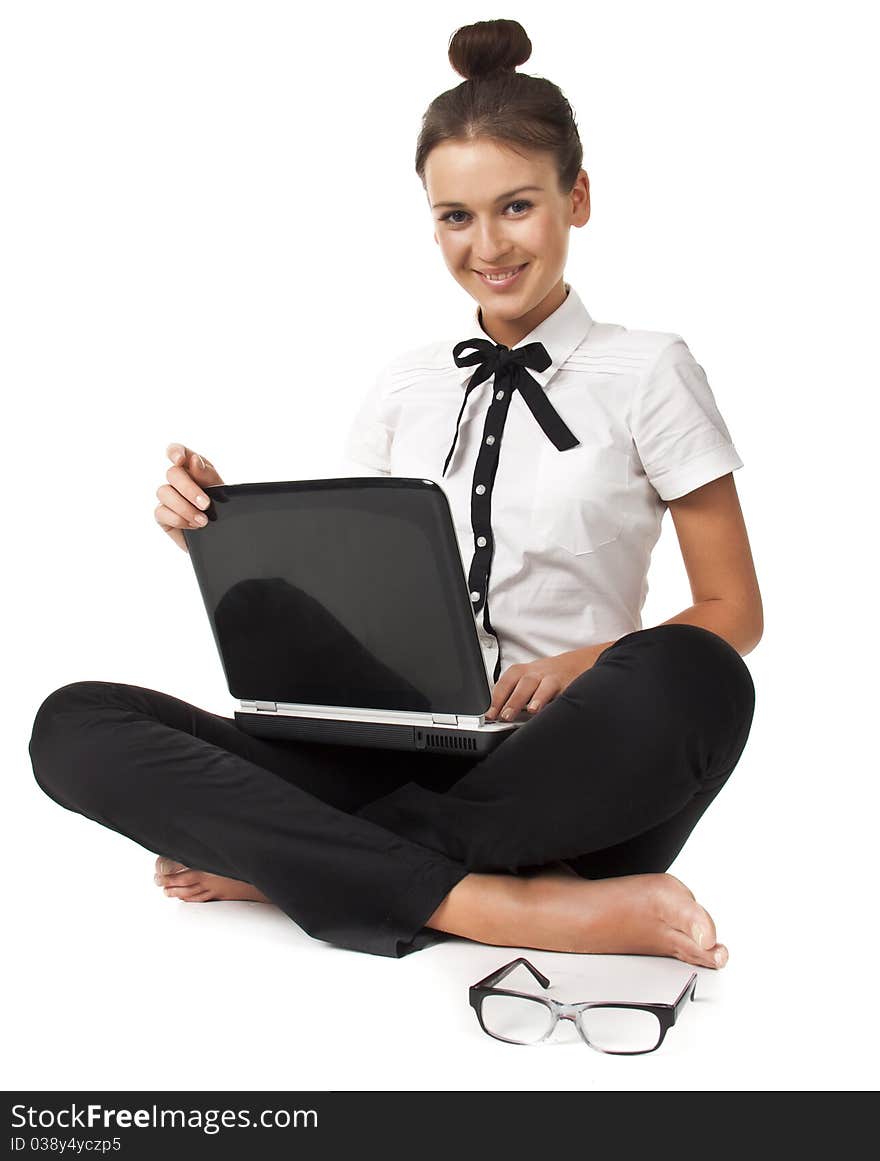 Beautiful girl sitting on the floor and works on a laptop keep the glasses in her hand isolated on white background Student Series