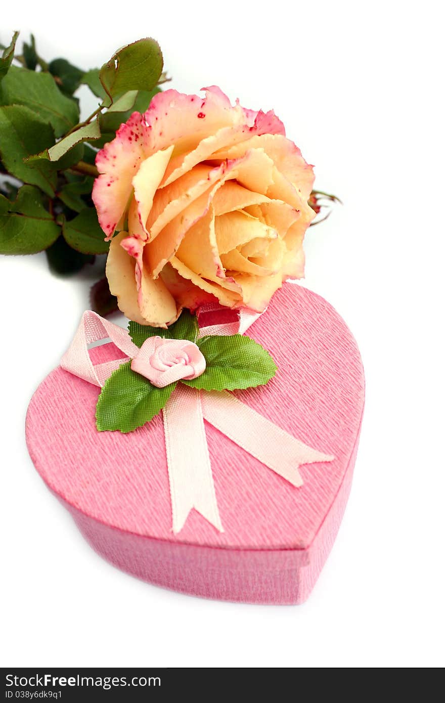 Isolated heart-shaped gift box with rose on it