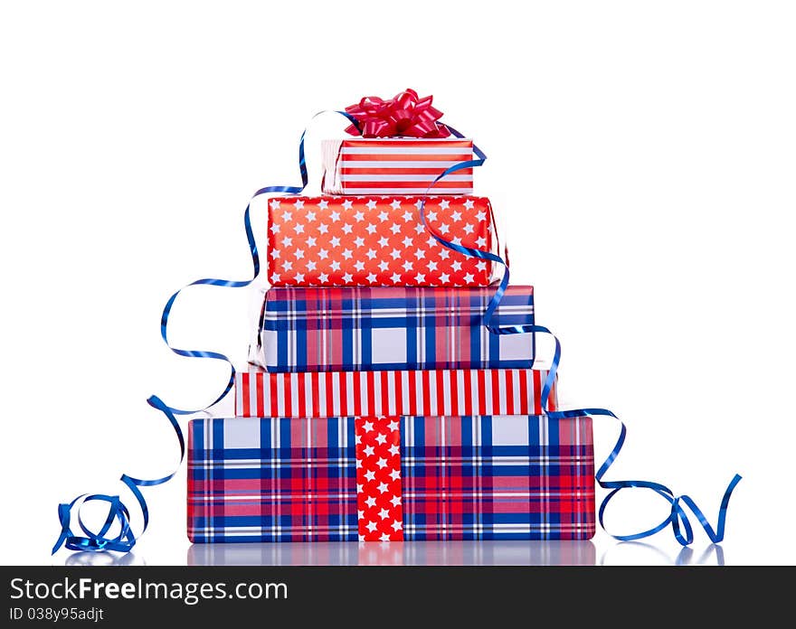 A stack of red white blue gifts with ribbon and bow isolated over white