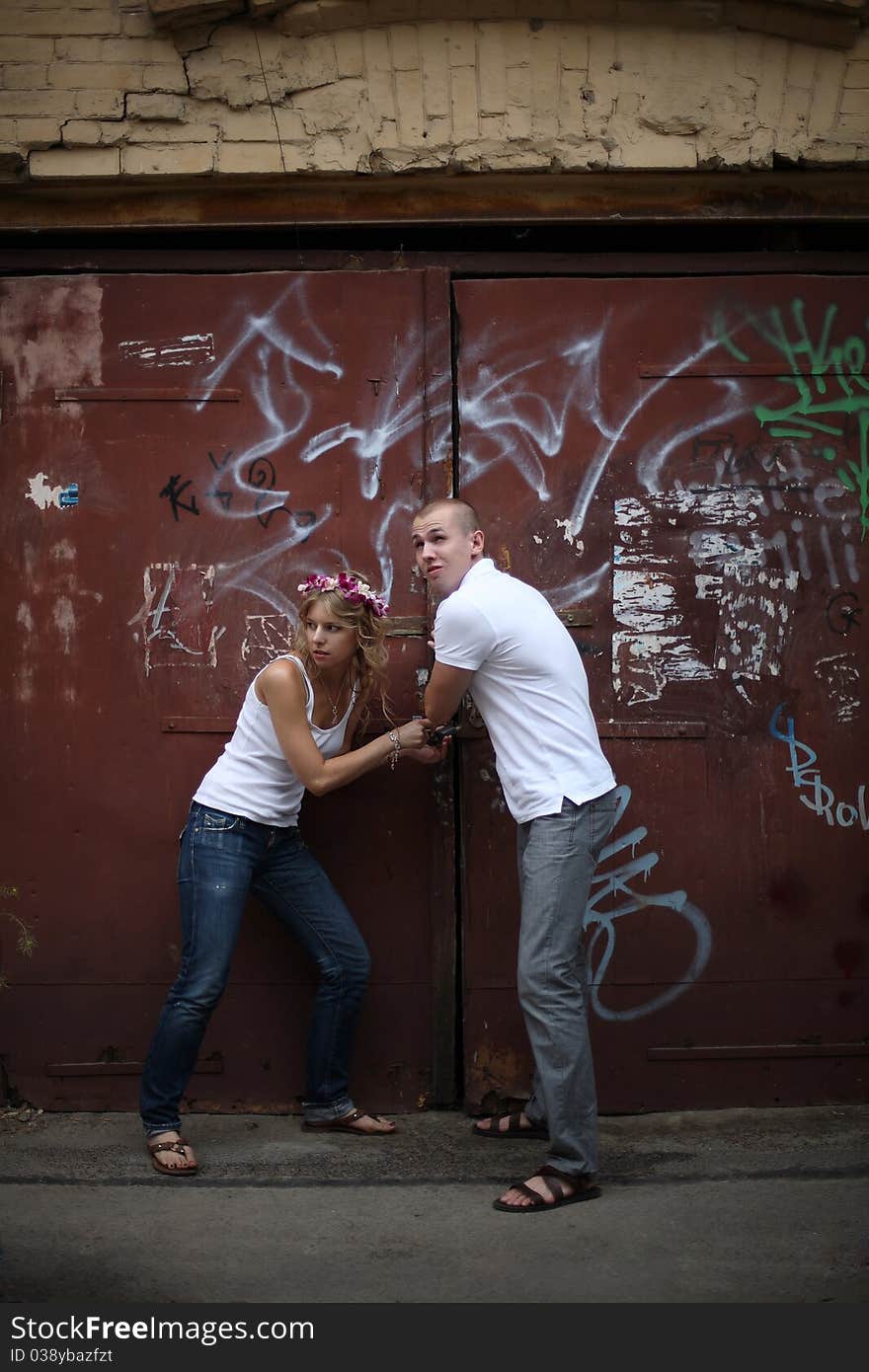 The guy and the girl breaking the lock on collars. The guy and the girl breaking the lock on collars