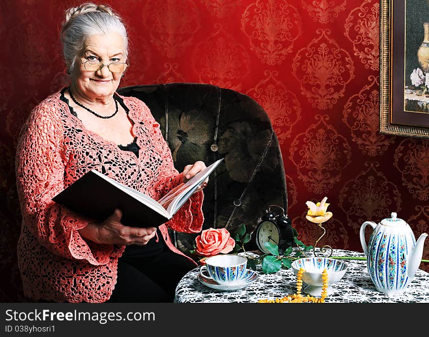 Portrait of a smiling senior woman having a rest at home. Portrait of a smiling senior woman having a rest at home.