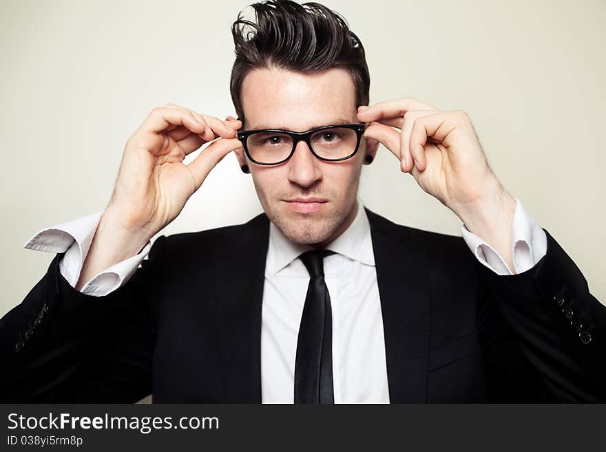 Young Businessman holding black glasses