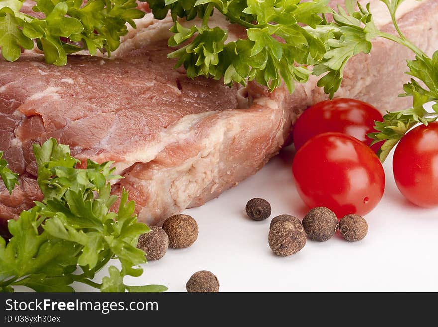 A large piece of raw meat on a white background.