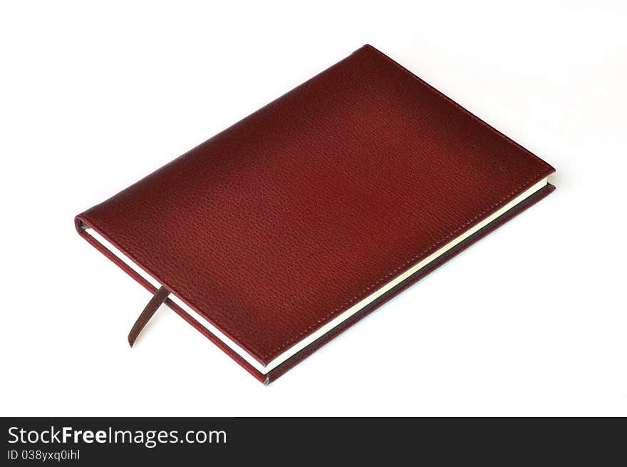 Dark red leather notebook on white background.