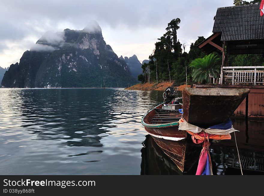 Long tailed boat floating on lake