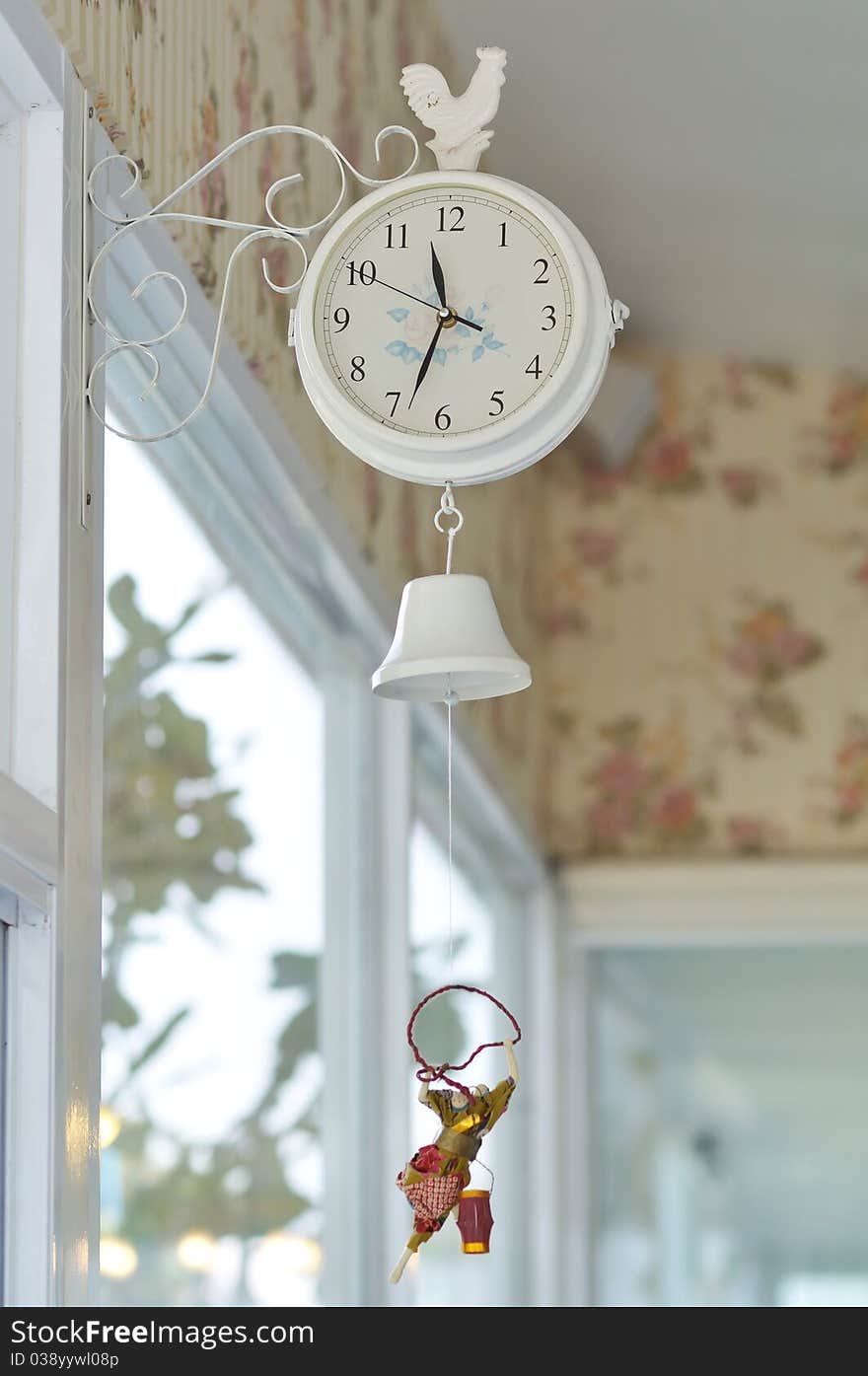 Cute white hanging clock decorated in coffee shop.