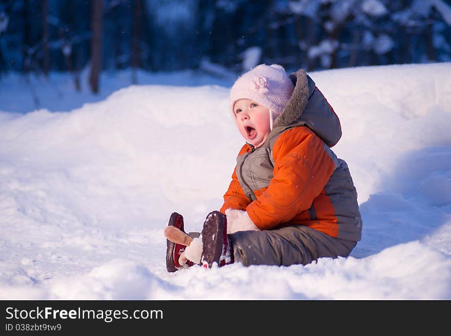 Cute adorable baby sit on snow in park