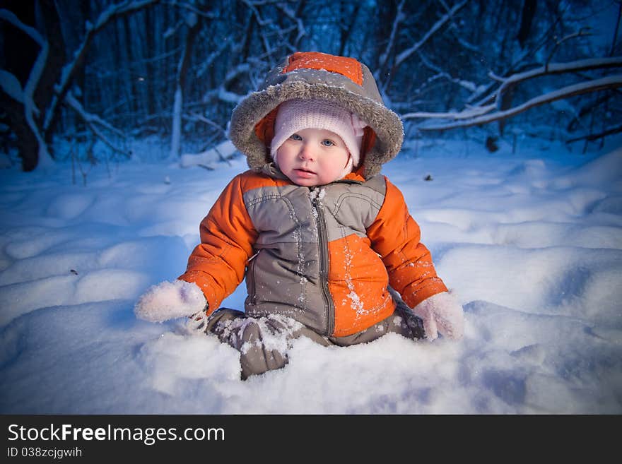 Adorable baby sit in deep snow