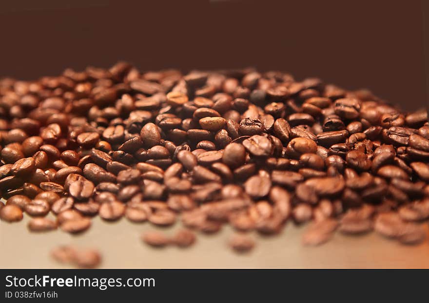 Closeup of coffee beans with focus on one. Closeup of coffee beans with focus on one